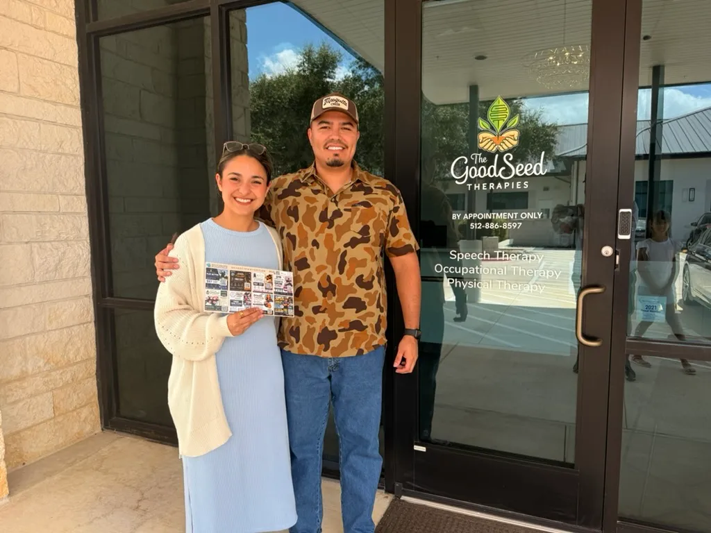 Two customers outside The Good Seed Therapies holding Dustin’s SpotDrops postcard